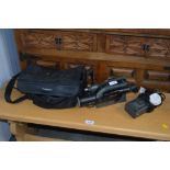 A Panasonic camcorder with carrying case and charg