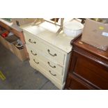 A cream painted chest fitted three long drawers