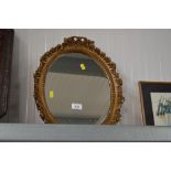 A gilt framed oval mirror