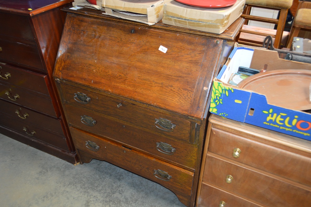 A 1920's/30's oak bureau fitted three long drawers
