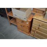 A pine bedside chest fitted three drawers