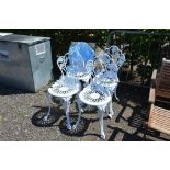 A set of four white painted ornate chairs