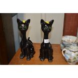 Two black glazed pottery cats, modelled in a seate