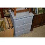 A grey painted three drawer bedside chest