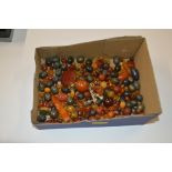 A tray of amber coloured and other beads