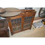 An oak and leaded glazed cabinet