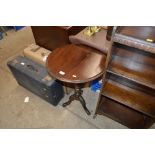 A mahogany circular topped table