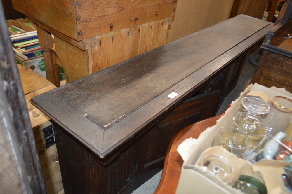 An oak linen fold decorated cupboard by Shapland &