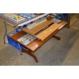 A teak and tile topped oblong coffee table