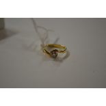 An 18ct gold diamond set crossover ring