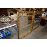 A large gilt framed and bevel edged mirror
