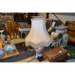 A floral decorated baluster table lamp and shade