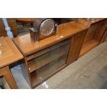 An oak bookcase with sliding glass doors