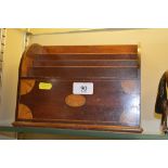 An Edwardian mahogany and inlaid stationery rack
