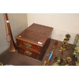 An Edwardian wooden table top chest fitted two dra