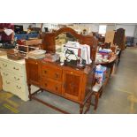 An oak mirrored back sideboard fitted two drawers