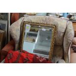 A gilt framed bevel edged oblong wall mirror