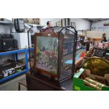 An oak cased fire screen depicting a hunting scene