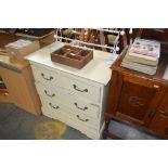 A cream painted chest fitted three drawers
