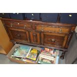 An oak sideboard, raised on barley twist supports,