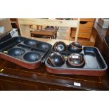 A cased set of four bowling woods
