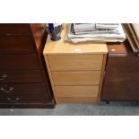 An oak effect three drawer bedside chest