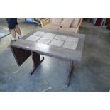 A tile top dining table with drop leaf