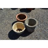 A blue glazed planter; a concrete planter; and a t