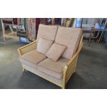 A beech and cane conservatory sofa