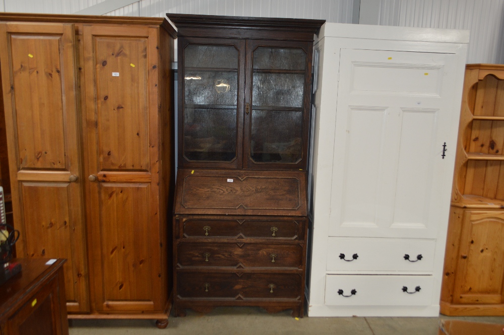 An oak bureau bookcase fitted three long drawers