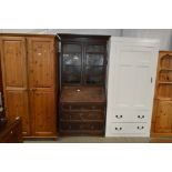 An oak bureau bookcase fitted three long drawers