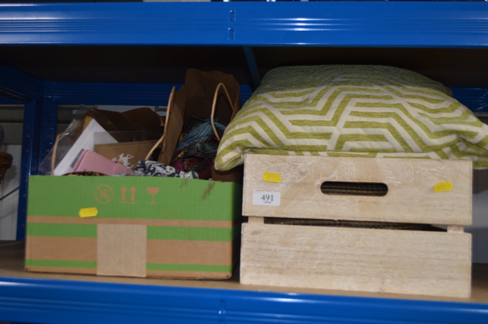 Two boxes containing various cushions, scarves, an