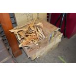 A box of various wooden coat hangers