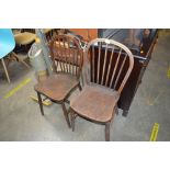 A pair of elm seated stick back dining chairs