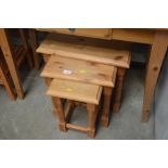 A nest of three pine occasional tables