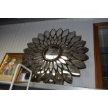 A decorative wall mirror in the form of a flower,