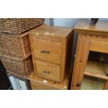 A hardwood bedside chest fitted two drawers