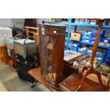 A small coffee table and a glazed corner cabinet