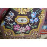 An approx. 5ft 10ins x 3ft floral patterned wool r