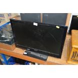 A Sharp flat screen television - lacking remote