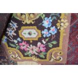 An approx. 5ft 10ins x 3ft floral patterned wool r
