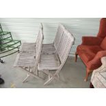 A set of four teak folding garden chairs