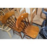 A pair of slat back dining chairs