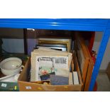 A box containing various pictures and prints, book