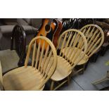 A set of four beech slat back dining chairs