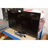 A Panasonic flat screen television with remote con