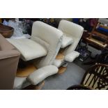 A pair of cream leather upholstered swivel chairs
