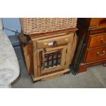 A hardwood cupboard with magazine rack and fitted