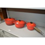 Three LeCreuset cooking dishes