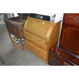 A modern pine bureau fitted four long drawers